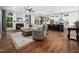 Open living space with a fireplace, large windows, and seamless flow to the kitchen and dining area at 3400 Appling Way, Durham, NC 27703