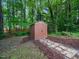 Outdoor storage shed in backyard with walkway and surrounding trees providing privacy at 3400 Appling Way, Durham, NC 27703
