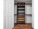 Well organized walk-in closet with dark shelving and wood accents at 3400 Appling Way, Durham, NC 27703