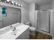 Clean bathroom featuring a shower, updated vanity with sink, new light fixture, and vinyl flooring at 3721 Suffolk St, Durham, NC 27707