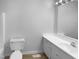 Bathroom features a toilet, sink, and vanity, all well-lit and in neutral tones at 3721 Suffolk St, Durham, NC 27707