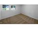 Bedroom with neutral carpet, paint, and two windows providing natural light at 3721 Suffolk St, Durham, NC 27707