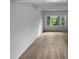 Bedroom with neutral carpet and a large window looking out to a leafy green tree at 3721 Suffolk St, Durham, NC 27707