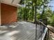 A close-up view of the deck with trees visible in the background at 3721 Suffolk St, Durham, NC 27707