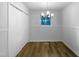 Dining room with modern light fixture, wood flooring, and a window for natural light at 3721 Suffolk St, Durham, NC 27707