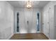 Inviting entryway featuring a double door, side windows, hardwood floor, and modern lighting fixture at 3721 Suffolk St, Durham, NC 27707