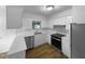 Bright kitchen featuring white cabinetry, modern stainless steel appliances, and a window over the sink at 3721 Suffolk St, Durham, NC 27707