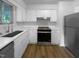 Recently renovated kitchen with stainless steel appliances, white cabinets, and lots of natural light at 3721 Suffolk St, Durham, NC 27707