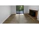 Open living room with vinyl flooring, a brick fireplace, and sliding glass doors leading to a deck at 3721 Suffolk St, Durham, NC 27707