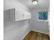 Study room with ample cabinet storage, natural light from a window, and hardwood flooring at 3721 Suffolk St, Durham, NC 27707
