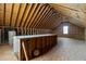 Spacious unfinished attic with exposed wood beams and one window at 40 Horizon Trl, Garner, NC 27529