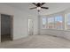 Spacious bedroom with natural light, a ceiling fan, and neutral-toned walls and carpet at 40 Horizon Trl, Garner, NC 27529
