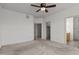 Spacious and airy bedroom with a fan, closet and doorway leading into another room at 40 Horizon Trl, Garner, NC 27529