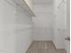 Bright walk-in closet with white wire shelving and carpeted floor, offering ample storage space at 40 Horizon Trl, Garner, NC 27529