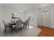 Bright dining room featuring an elegant chandelier, a large window, and neutral color scheme at 40 Horizon Trl, Garner, NC 27529