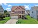 Charming two-story home featuring a stone facade, red shutters and a well-manicured lawn at 40 Horizon Trl, Garner, NC 27529
