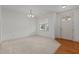 Bright living room featuring a large window, hardwood and carpet floors, and neutral color scheme at 40 Horizon Trl, Garner, NC 27529
