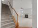 A staircase with carpeted steps and wooden handrails leading up to the main living area at 40 Horizon Trl, Garner, NC 27529