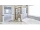 Bathroom featuring tile flooring, standalone tub, and large glass shower at 405 Falls Bluff Dr, Wake Forest, NC 27596