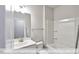 Standard bathroom with a shower-tub combo and a vanity with a mirror at 405 Falls Bluff Dr, Wake Forest, NC 27596