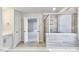 Bathroom featuring tile flooring, standalone tub, and large glass shower at 405 Falls Bluff Dr, Wake Forest, NC 27596