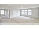 Spacious bonus room with plush carpeting, large windows, and ample natural light at 405 Falls Bluff Dr, Wake Forest, NC 27596