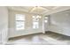 Bright dining room with a tray ceiling, chandelier, wainscoting, hardwood floors, and large windows at 405 Falls Bluff Dr, Wake Forest, NC 27596
