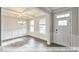 Charming dining room boasting natural light, coffered ceilings, wainscoting, and beautiful hardwood floors at 405 Falls Bluff Dr, Wake Forest, NC 27596