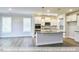 Open-concept kitchen with a large island, stainless steel appliances, and hardwood floors at 405 Falls Bluff Dr, Wake Forest, NC 27596
