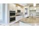 Gourmet kitchen with double ovens, stainless steel appliances, and a large island with sink at 405 Falls Bluff Dr, Wake Forest, NC 27596