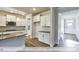 Modern kitchen with white cabinets, stainless steel appliances, and an island with countertop at 405 Falls Bluff Dr, Wake Forest, NC 27596