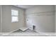 A simple laundry room offers tile flooring and a utility closet with a wire rack and window at 405 Falls Bluff Dr, Wake Forest, NC 27596