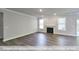 Large living room featuring a fireplace, hardwood floors, ample natural light, and neutral paint at 405 Falls Bluff Dr, Wake Forest, NC 27596