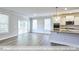 Open concept living area showcasing hardwood floors, a walkout to the porch, and an eat-in kitchen at 405 Falls Bluff Dr, Wake Forest, NC 27596