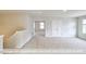 Spacious loft area with carpet, multiple windows and doorways at 405 Falls Bluff Dr, Wake Forest, NC 27596
