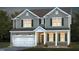 Charming two-story home featuring a two-car garage, green shutters, and inviting front porch at 465 Grange Farm Pl, Raleigh, NC 27603