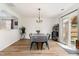 Bright dining room with wood floors, chandelier, and sliding door to patio at 4712 Rockport Dr, Durham, NC 27703