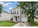 Traditional exterior elevation with manicured front lawn, garage, and mature trees at 4712 Rockport Dr, Durham, NC 27703