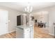 Bright kitchen featuring an island, stainless steel appliances, and wood look flooring at 4712 Rockport Dr, Durham, NC 27703