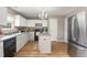 Spacious kitchen with stainless steel appliances, gray countertops and an eat-in island at 4712 Rockport Dr, Durham, NC 27703