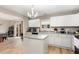 Bright kitchen features white cabinets, an island, and wood-look floors for a modern, clean aesthetic at 4712 Rockport Dr, Durham, NC 27703