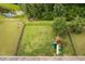Aerial view of the fenced backyard featuring a playset, lawn, and mature trees at 5028 Blue Jack Oak Dr, Cary, NC 27519