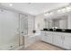Bright bathroom featuring a double vanity, black granite countertops, and a glass shower with a tub at 5028 Blue Jack Oak Dr, Cary, NC 27519