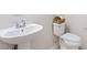 Bathroom featuring a white pedestal sink and toilet with a decorative basket on top at 5028 Blue Jack Oak Dr, Cary, NC 27519
