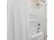 View of a white shower/tub combo with chrome hardware and a white shower curtain at 5028 Blue Jack Oak Dr, Cary, NC 27519