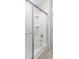 Clean bathroom featuring a combination shower and tub with sliding doors, and updated shower fixtures at 5028 Blue Jack Oak Dr, Cary, NC 27519