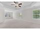 Large bright bedroom featuring multiple windows and a ceiling fan at 5028 Blue Jack Oak Dr, Cary, NC 27519
