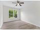 Bedroom featuring wood-look floors, a ceiling fan, and a large window overlooking the backyard at 5028 Blue Jack Oak Dr, Cary, NC 27519