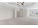 Spacious bedroom featuring a ceiling fan and closet doors at 5028 Blue Jack Oak Dr, Cary, NC 27519