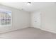 Bright bedroom featuring neutral walls, plush carpet, a closet, and one window with horizontal blinds at 5028 Blue Jack Oak Dr, Cary, NC 27519